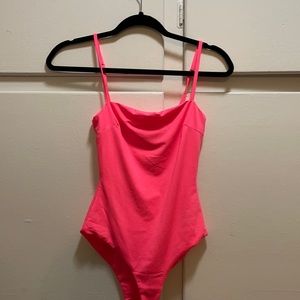 hot pink body suit